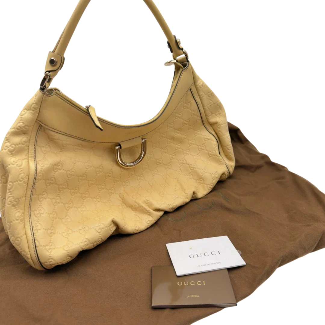 https://cdn.shopify.com/s/files/1/0564/9376/8855/files/Gucci_Schultertasche_D-Ring_large_aus_Leder_monogram_gelb_22.webp?v=1784281400