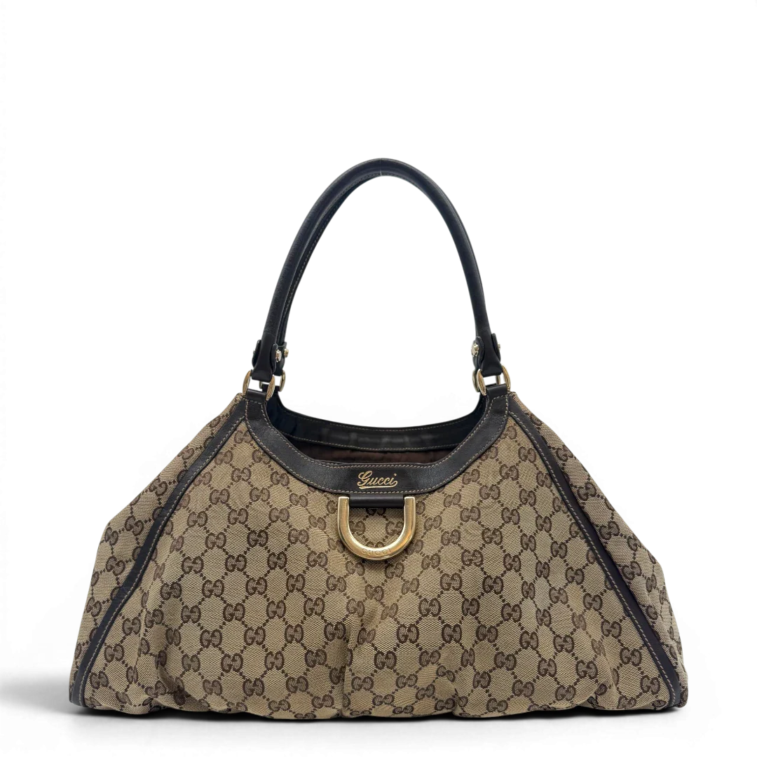 https://cdn.shopify.com/s/files/1/0564/9376/8855/files/Gucci_Schultertasche_D-Ring_large_monogram_beige_vintage_GG6963.webp?v=1779289890