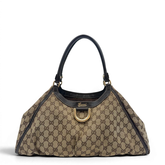 https://cdn.shopify.com/s/files/1/0564/9376/8855/files/Gucci_Schultertasche_D-Ring_large_monogram_beige_vintage_GG6963.webp?v=1779289890