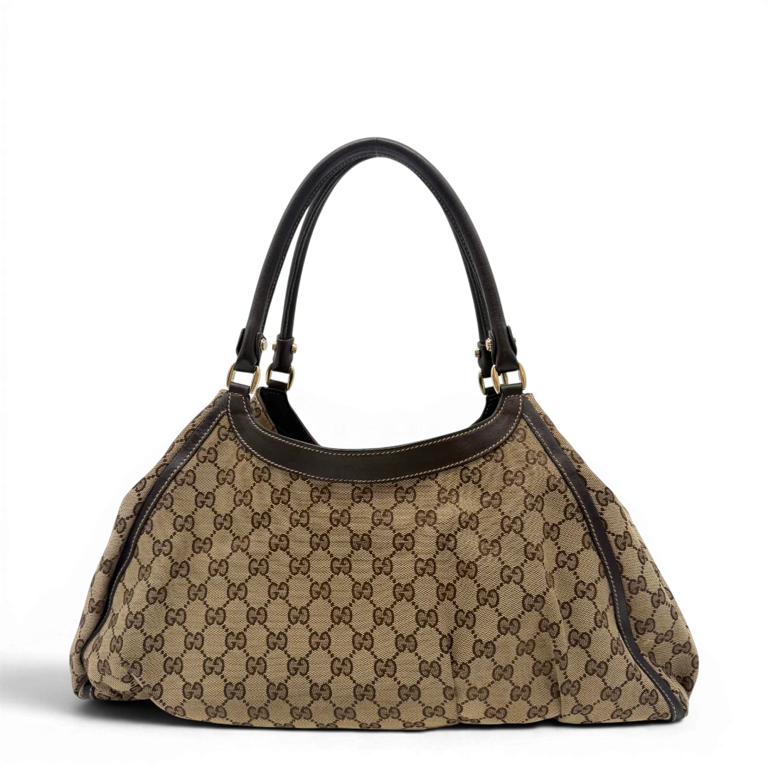 https://cdn.shopify.com/s/files/1/0564/9376/8855/files/Gucci_Schultertasche_D-Ring_large_monogram_beige_vintage_GG6964.webp?v=1779289890