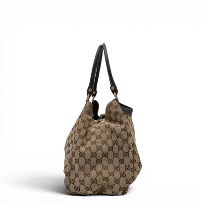 https://cdn.shopify.com/s/files/1/0564/9376/8855/files/Gucci_Schultertasche_D-Ring_large_monogram_beige_vintage_GG6965.webp?v=1779289890