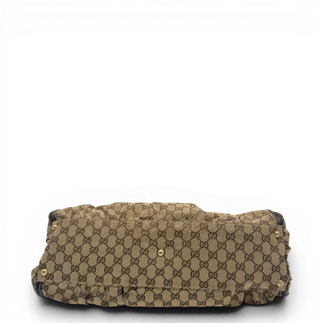 https://cdn.shopify.com/s/files/1/0564/9376/8855/files/Gucci_Schultertasche_D-Ring_large_monogram_beige_vintage_GG6967.webp?v=1779289889