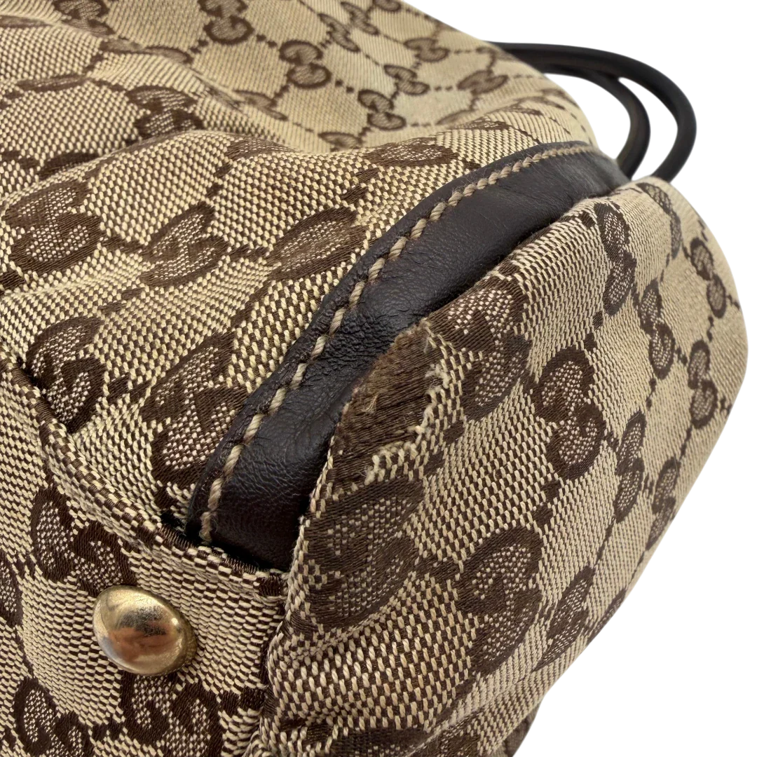 https://cdn.shopify.com/s/files/1/0564/9376/8855/files/Gucci_Schultertasche_D-Ring_large_monogram_beige_vintage_GG6968.webp?v=1779289890