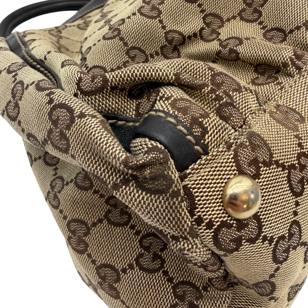https://cdn.shopify.com/s/files/1/0564/9376/8855/files/Gucci_Schultertasche_D-Ring_large_monogram_beige_vintage_GG6971.webp?v=1779289890