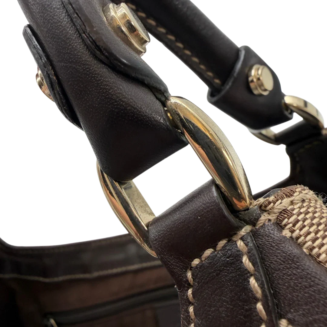 https://cdn.shopify.com/s/files/1/0564/9376/8855/files/Gucci_Schultertasche_D-Ring_large_monogram_beige_vintage_GG6973.webp?v=1779289889