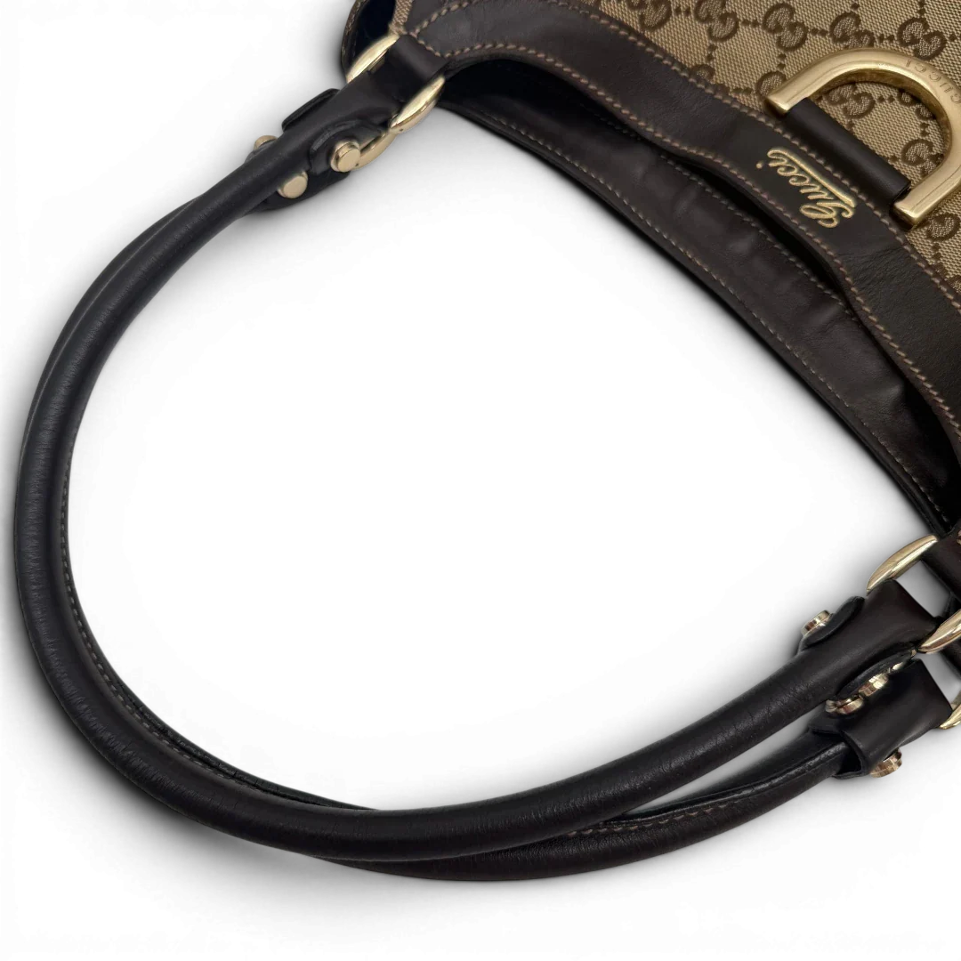 https://cdn.shopify.com/s/files/1/0564/9376/8855/files/Gucci_Schultertasche_D-Ring_large_monogram_beige_vintage_GG6975.webp?v=1779289889