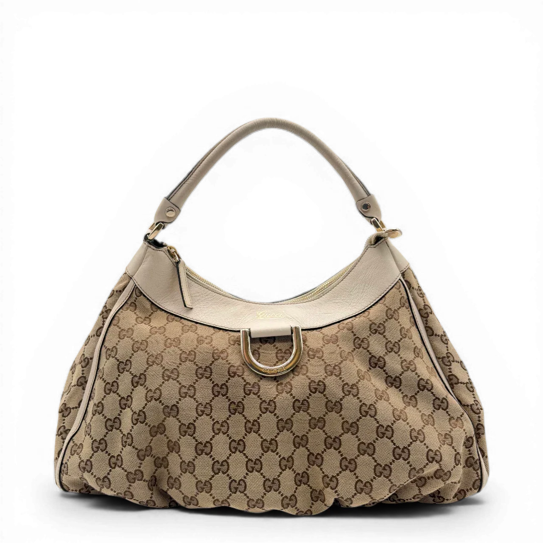 https://cdn.shopify.com/s/files/1/0564/9376/8855/files/Gucci_Schultertasche_D-Ring_large_monogram_beige_vintage_GG_1490.webp?v=1772707062