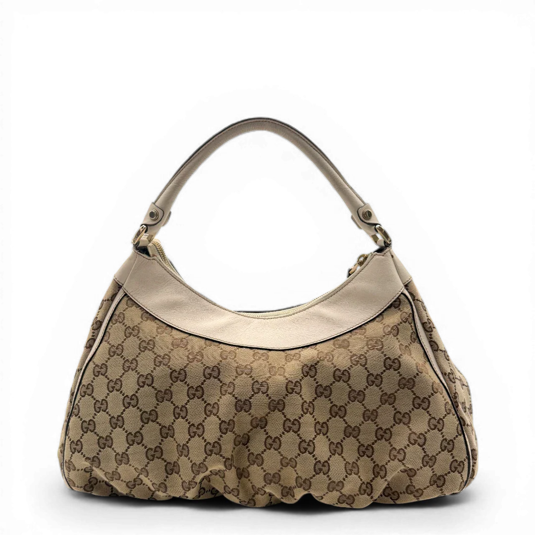 https://cdn.shopify.com/s/files/1/0564/9376/8855/files/Gucci_Schultertasche_D-Ring_large_monogram_beige_vintage_GG_1492.webp?v=1772707096