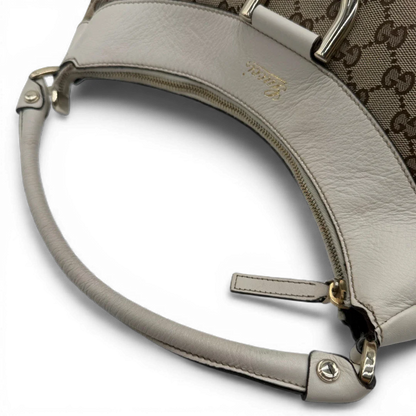 https://cdn.shopify.com/s/files/1/0564/9376/8855/files/Gucci_Schultertasche_D-Ring_large_monogram_beige_vintage_GG_1500.webp?v=1772707096
