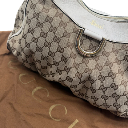 https://cdn.shopify.com/s/files/1/0564/9376/8855/files/Gucci_Schultertasche_D-Ring_large_monogram_beige_vintage_GG_1511.webp?v=1772707096