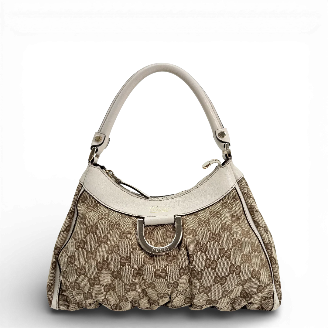 https://cdn.shopify.com/s/files/1/0564/9376/8855/files/Gucci_Schultertasche_D-Ring_medium_Lederdetails_weiss_monogram_beige_vintage_GG_0955.webp?v=1770890468