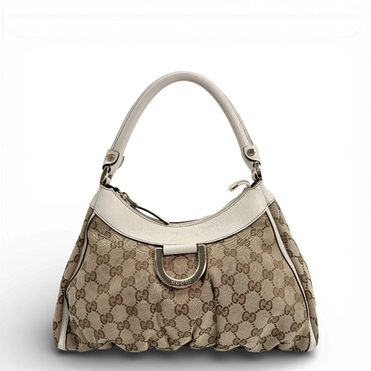 https://cdn.shopify.com/s/files/1/0564/9376/8855/files/Gucci_Schultertasche_D-Ring_medium_Lederdetails_weiss_monogram_beige_vintage_GG_0955.webp?v=1770890468