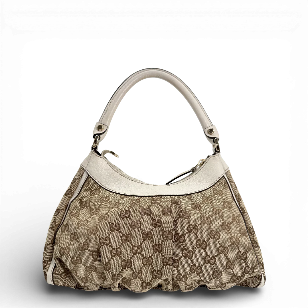 https://cdn.shopify.com/s/files/1/0564/9376/8855/files/Gucci_Schultertasche_D-Ring_medium_Lederdetails_weiss_monogram_beige_vintage_GG_0956.webp?v=1770890512