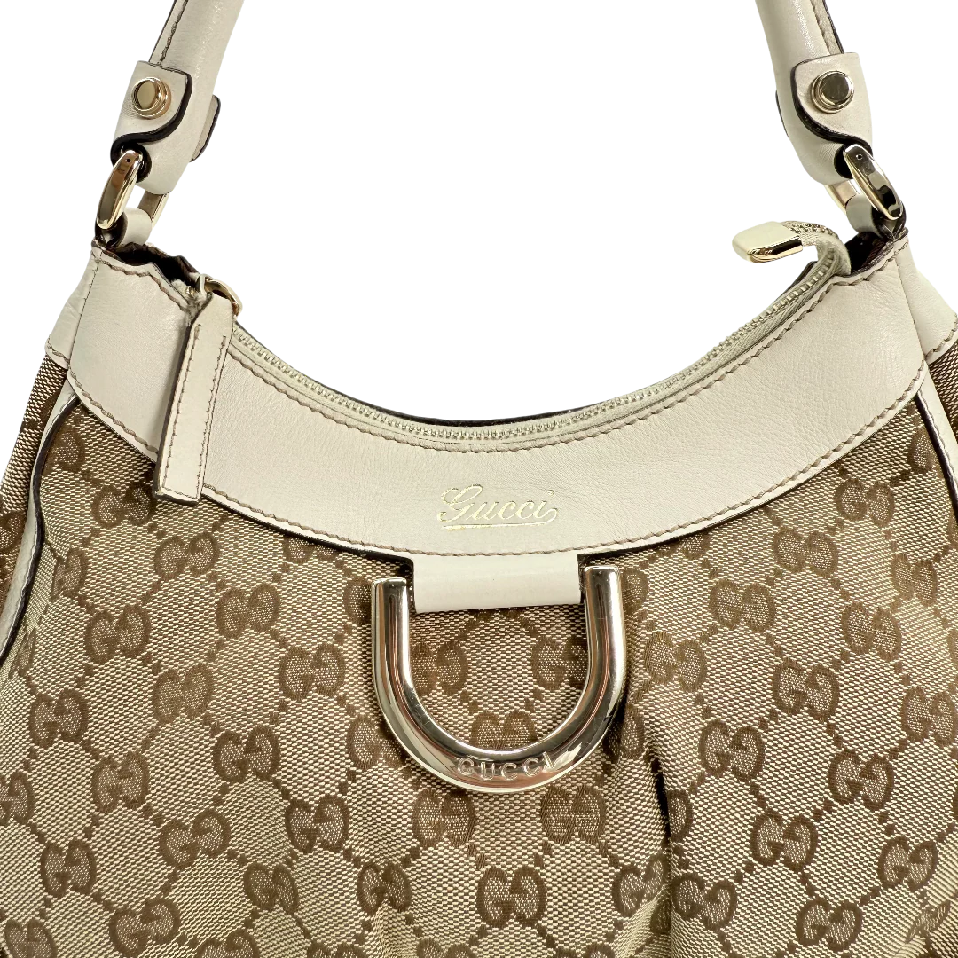 https://cdn.shopify.com/s/files/1/0564/9376/8855/files/Gucci_Schultertasche_D-Ring_medium_Lederdetails_weiss_monogram_beige_vintage_GG_0966.webp?v=1770890512