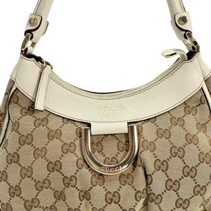 https://cdn.shopify.com/s/files/1/0564/9376/8855/files/Gucci_Schultertasche_D-Ring_medium_Lederdetails_weiss_monogram_beige_vintage_GG_0966.webp?v=1770890512