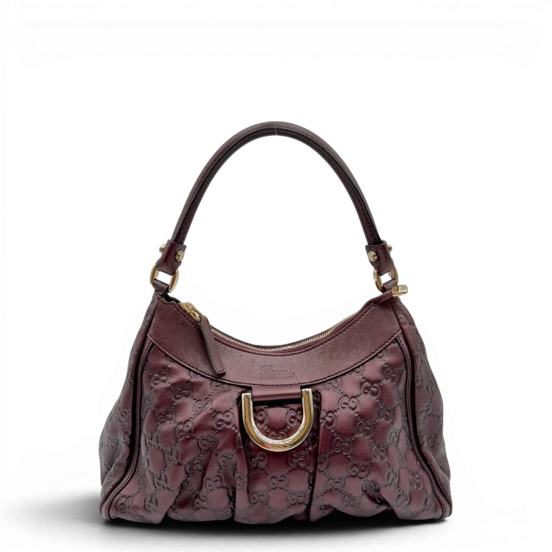 https://cdn.shopify.com/s/files/1/0564/9376/8855/files/Gucci_Schultertasche_D-Ring_medium_aus_Leder_monogram_lila_1.webp?v=1784283698