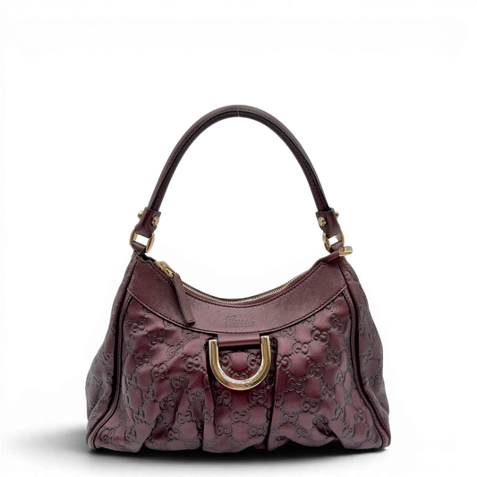https://cdn.shopify.com/s/files/1/0564/9376/8855/files/Gucci_Schultertasche_D-Ring_medium_aus_Leder_monogram_lila_1.webp?v=1784283698