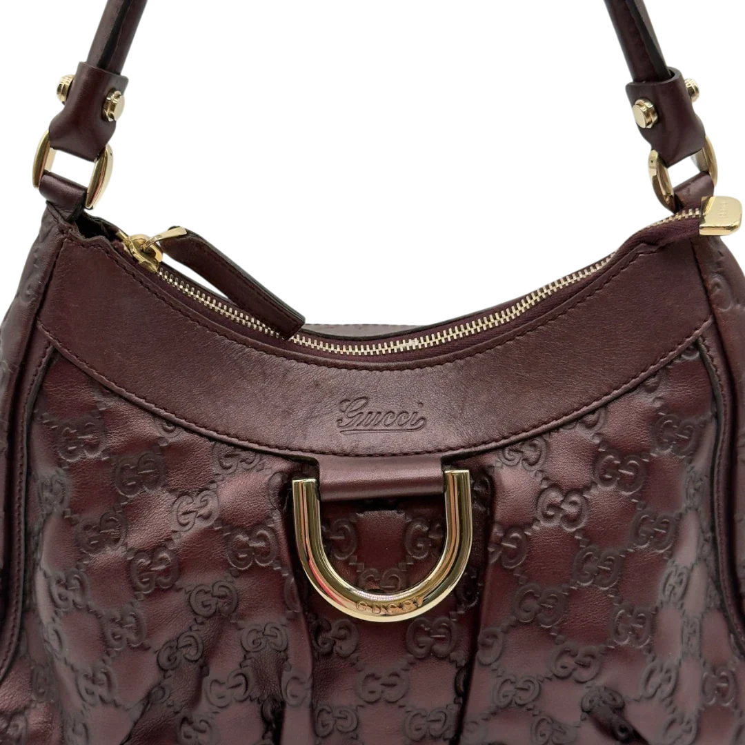 https://cdn.shopify.com/s/files/1/0564/9376/8855/files/Gucci_Schultertasche_D-Ring_medium_aus_Leder_monogram_lila_11.webp?v=1784283698
