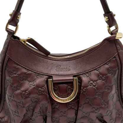 https://cdn.shopify.com/s/files/1/0564/9376/8855/files/Gucci_Schultertasche_D-Ring_medium_aus_Leder_monogram_lila_11.webp?v=1784283698