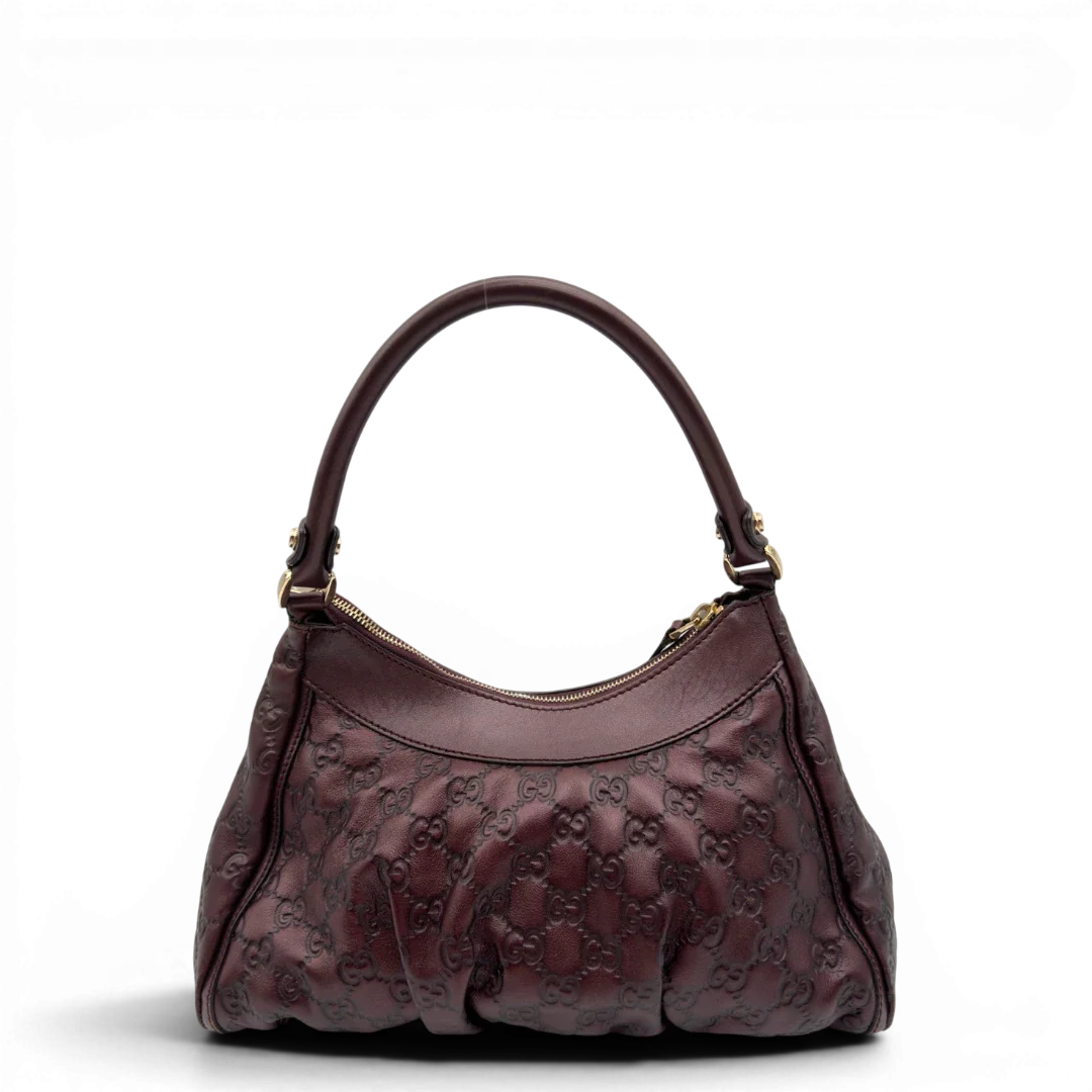 https://cdn.shopify.com/s/files/1/0564/9376/8855/files/Gucci_Schultertasche_D-Ring_medium_aus_Leder_monogram_lila_2.webp?v=1784283698