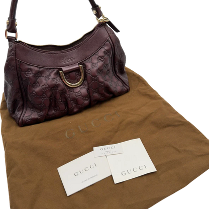 https://cdn.shopify.com/s/files/1/0564/9376/8855/files/Gucci_Schultertasche_D-Ring_medium_aus_Leder_monogram_lila_23.webp?v=1784283698