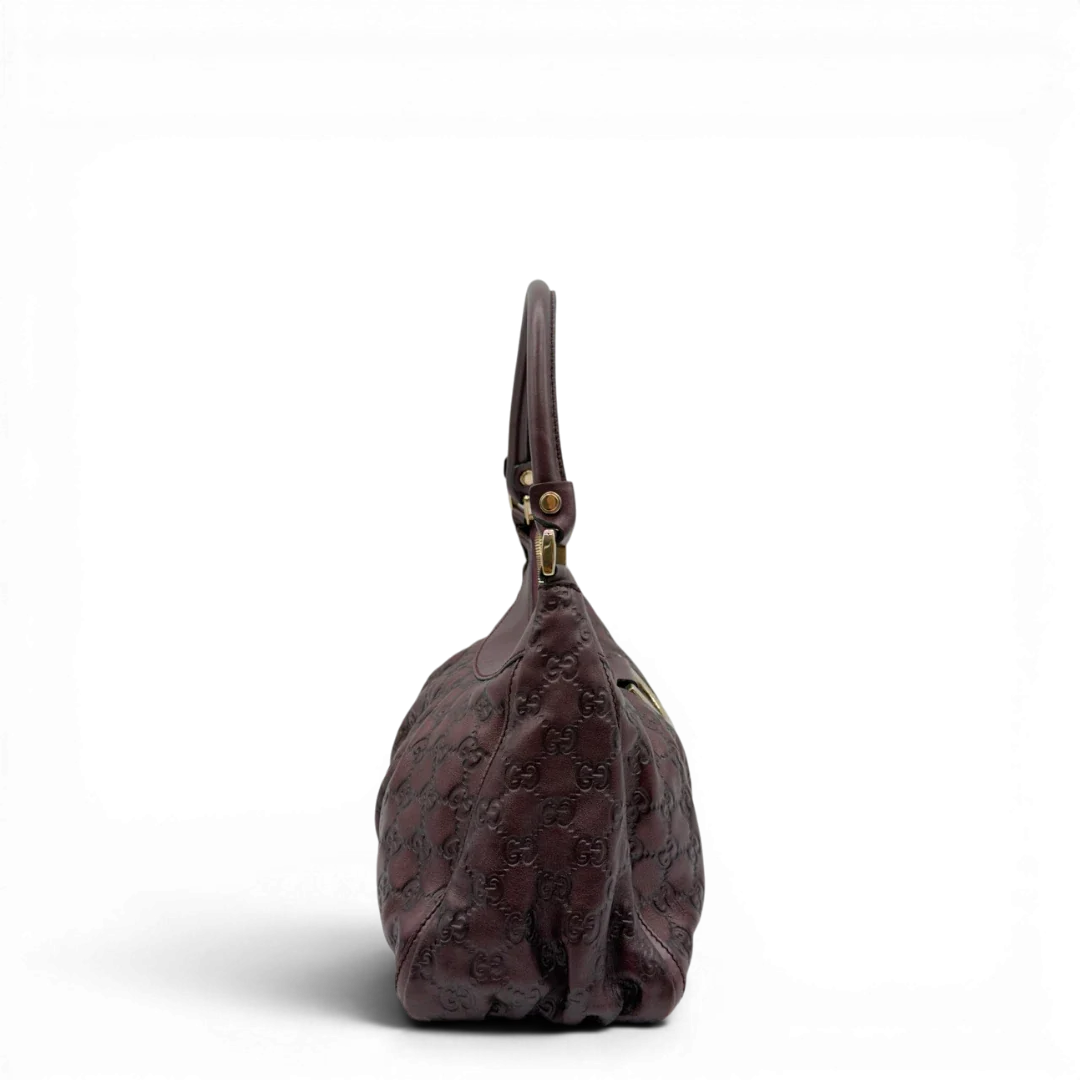 https://cdn.shopify.com/s/files/1/0564/9376/8855/files/Gucci_Schultertasche_D-Ring_medium_aus_Leder_monogram_lila_3.webp?v=1784283698