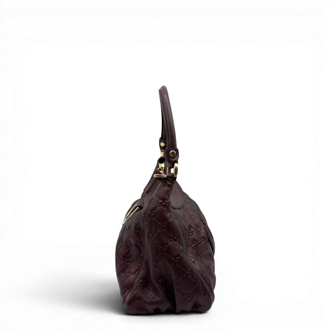 https://cdn.shopify.com/s/files/1/0564/9376/8855/files/Gucci_Schultertasche_D-Ring_medium_aus_Leder_monogram_lila_4.webp?v=1784283698