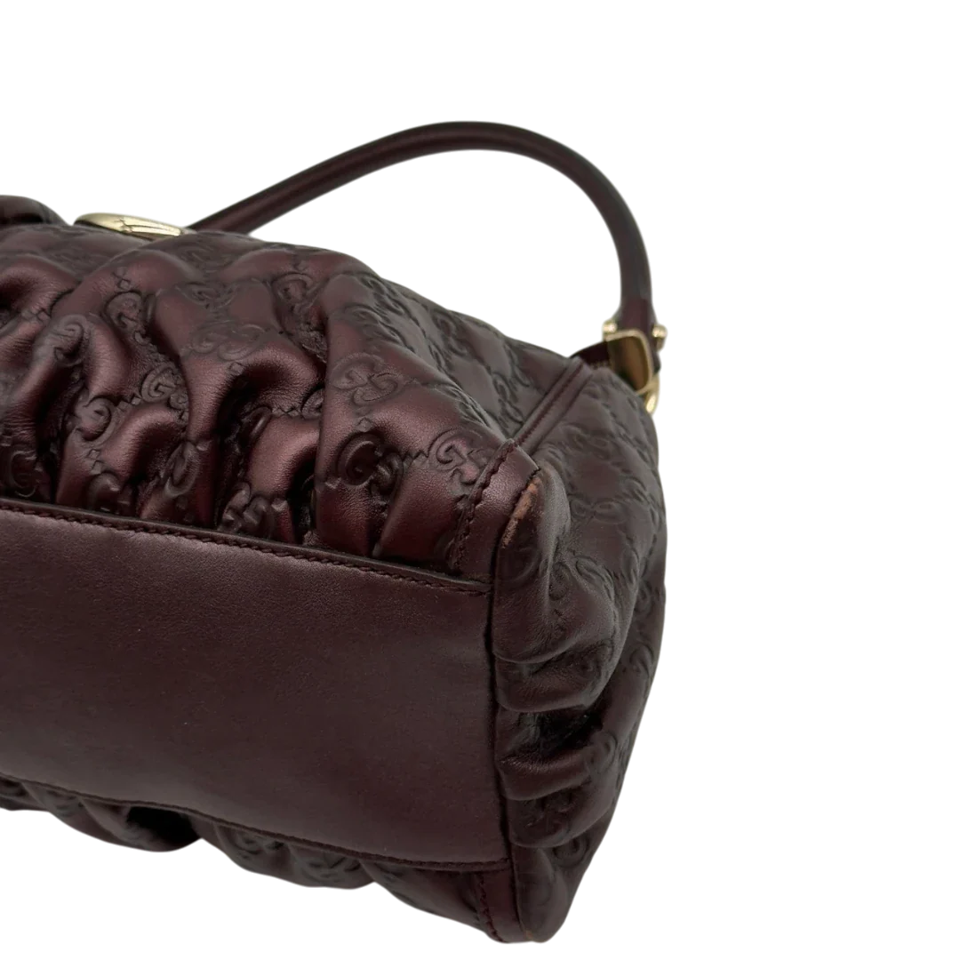 https://cdn.shopify.com/s/files/1/0564/9376/8855/files/Gucci_Schultertasche_D-Ring_medium_aus_Leder_monogram_lila_6.webp?v=1784283698