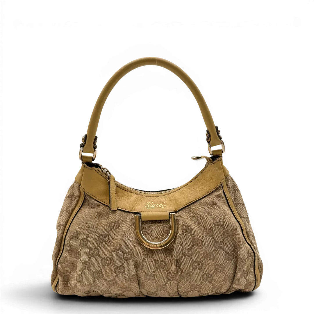 https://cdn.shopify.com/s/files/1/0564/9376/8855/files/Gucci_Schultertasche_D-Ring_medium_monogram_beige_1.webp?v=1782378063