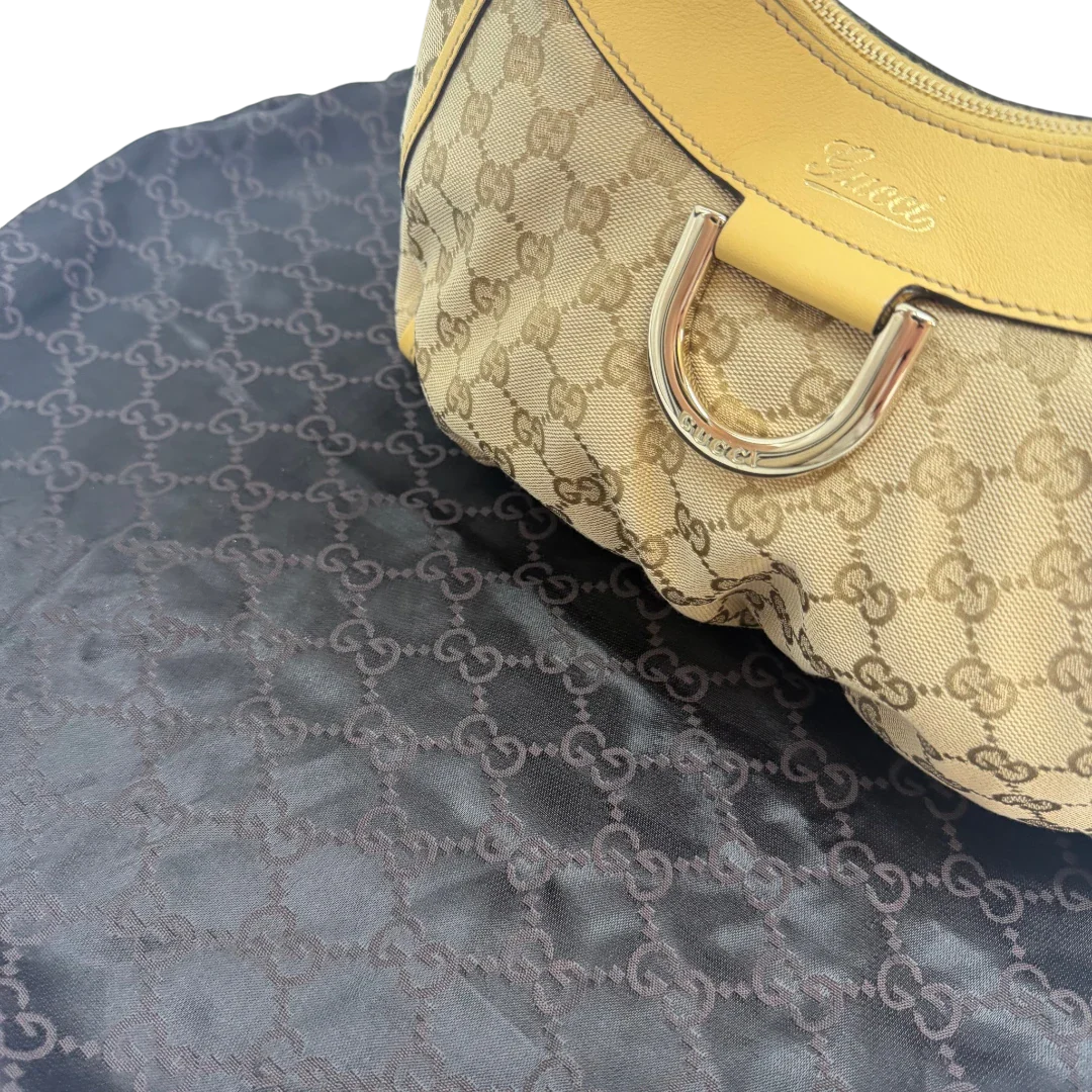 https://cdn.shopify.com/s/files/1/0564/9376/8855/files/Gucci_Schultertasche_D-Ring_medium_monogram_beige_vintage_GG6913.webp?v=1779286243