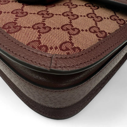 https://cdn.shopify.com/s/files/1/0564/9376/8855/files/Gucci_Schultertasche_Horsebit_1955_medium_monogram_rot_GG_shoulder_bag1037.webp?v=1761266552
