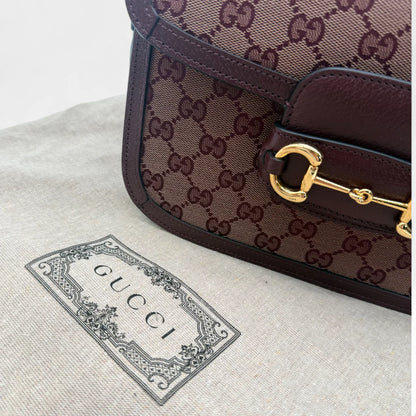 https://cdn.shopify.com/s/files/1/0564/9376/8855/files/Gucci_Schultertasche_Horsebit_1955_medium_monogram_rot_GG_shoulder_bag1057.webp?v=1761266552