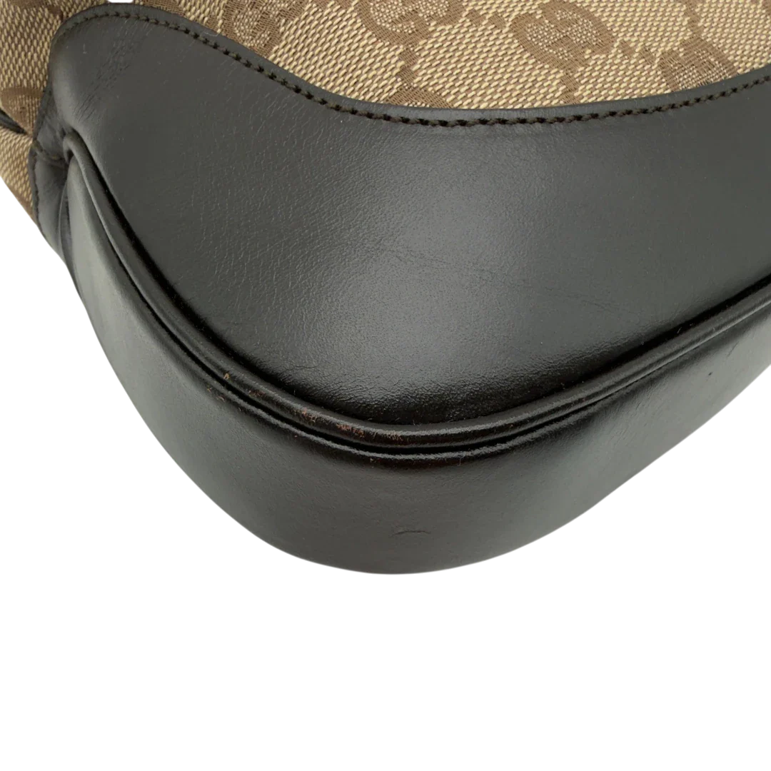 https://cdn.shopify.com/s/files/1/0564/9376/8855/files/Gucci_Schultertasche_Jackie_Sherry_Line_monogram_beige_vintage_GG7466.webp?v=1779290407