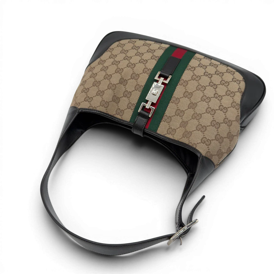 https://cdn.shopify.com/s/files/1/0564/9376/8855/files/Gucci_Schultertasche_Jackie_Sherry_Line_monogram_beige_vintage_GG7469.webp?v=1779290407