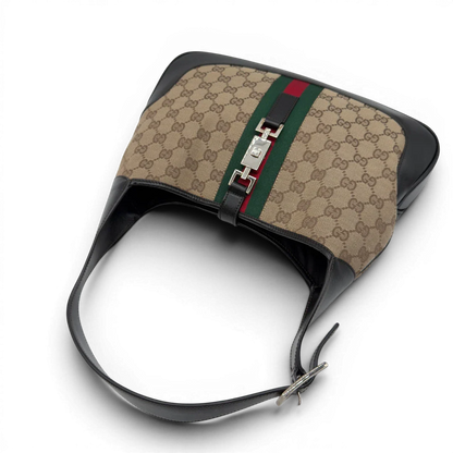 https://cdn.shopify.com/s/files/1/0564/9376/8855/files/Gucci_Schultertasche_Jackie_Sherry_Line_monogram_beige_vintage_GG7469.webp?v=1779290407