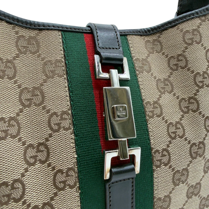 https://cdn.shopify.com/s/files/1/0564/9376/8855/files/Gucci_Schultertasche_Jackie_Sherry_Line_monogram_beige_vintage_GG7470.webp?v=1779290408