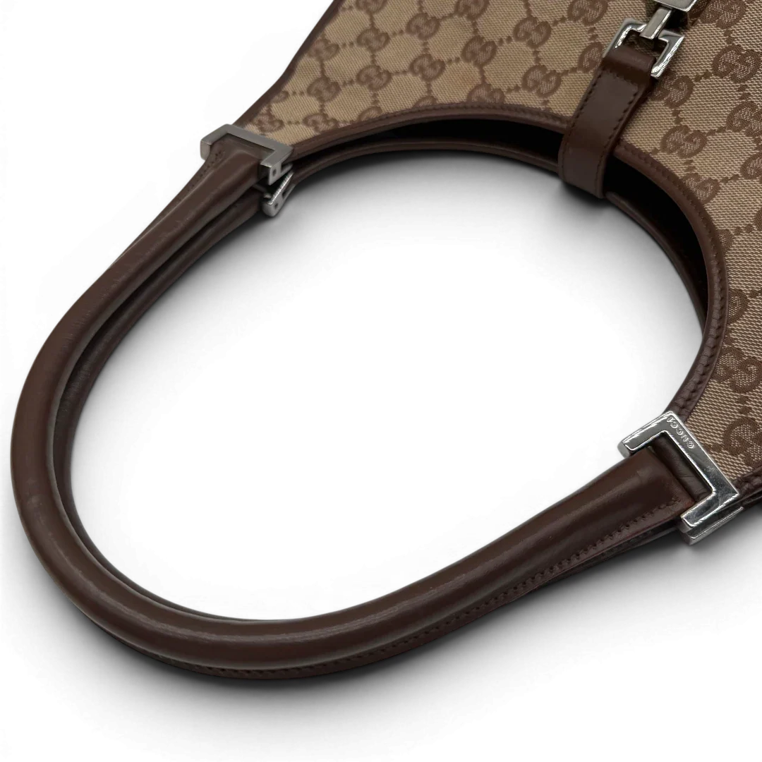 https://cdn.shopify.com/s/files/1/0564/9376/8855/files/Gucci_Schultertasche_Jackie_monogram_beige___braun_vintage_GG7386.webp?v=1779964271