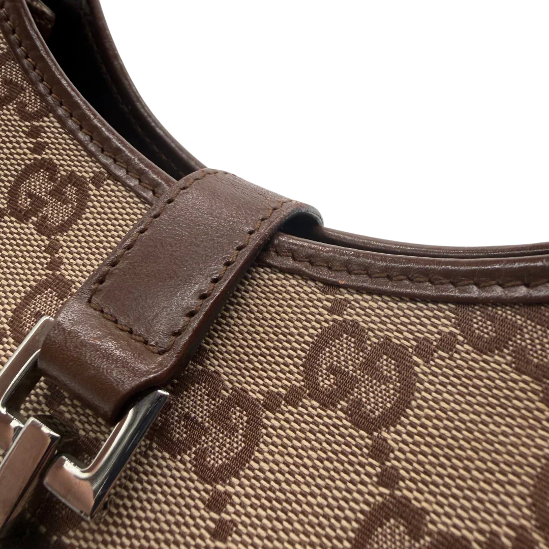 https://cdn.shopify.com/s/files/1/0564/9376/8855/files/Gucci_Schultertasche_Jackie_monogram_beige___braun_vintage_GG7389.webp?v=1779964271
