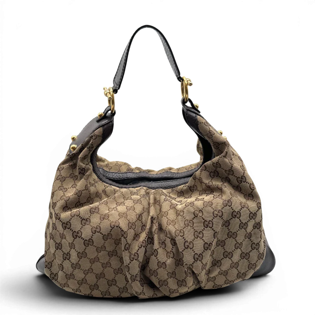 https://cdn.shopify.com/s/files/1/0564/9376/8855/files/Gucci_Schultertasche_Jockey_Hobo_large_monogram_beige_1.webp?v=1783516120