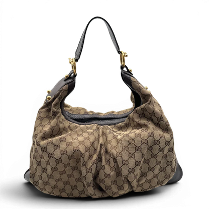 https://cdn.shopify.com/s/files/1/0564/9376/8855/files/Gucci_Schultertasche_Jockey_Hobo_large_monogram_beige_1.webp?v=1783516120