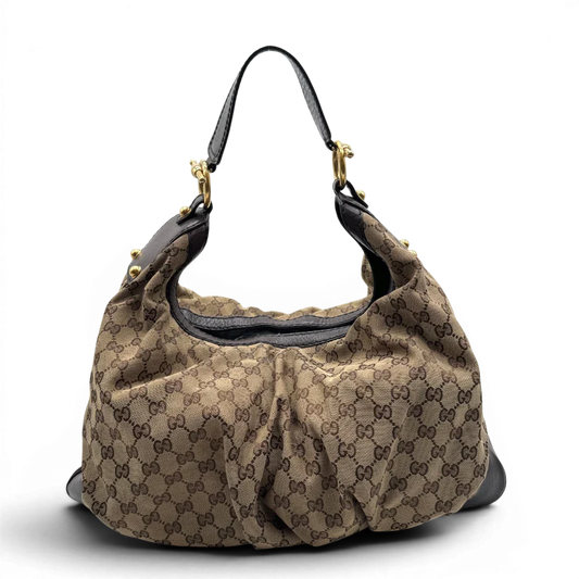 https://cdn.shopify.com/s/files/1/0564/9376/8855/files/Gucci_Schultertasche_Jockey_Hobo_large_monogram_beige_1.webp?v=1783516120