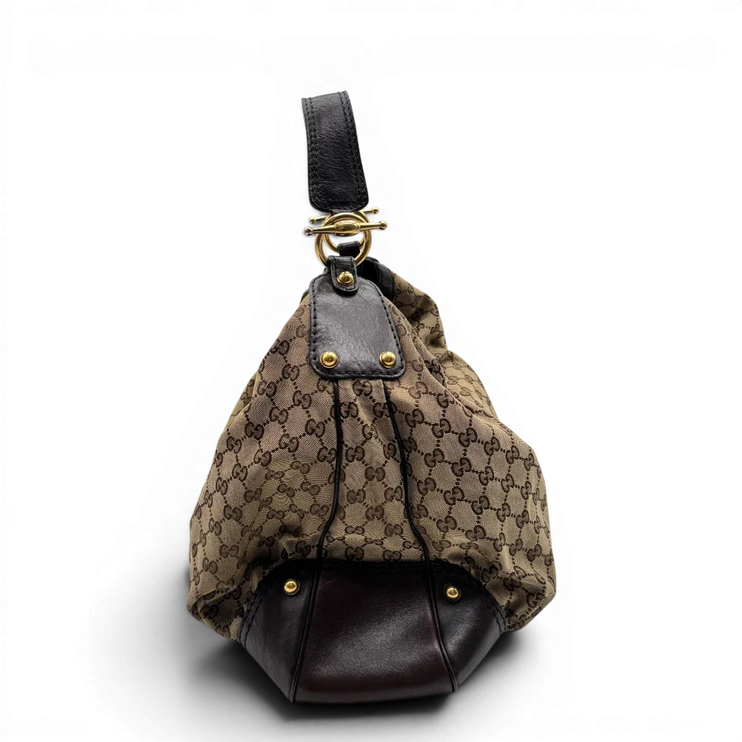 https://cdn.shopify.com/s/files/1/0564/9376/8855/files/Gucci_Schultertasche_Jockey_Hobo_large_monogram_beige_2.webp?v=1783516121