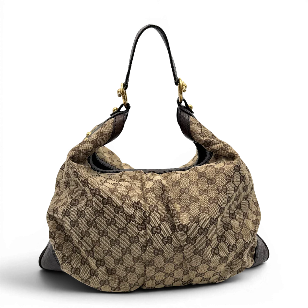 https://cdn.shopify.com/s/files/1/0564/9376/8855/files/Gucci_Schultertasche_Jockey_Hobo_large_monogram_beige_vintage_GG2149.webp?v=1779963372