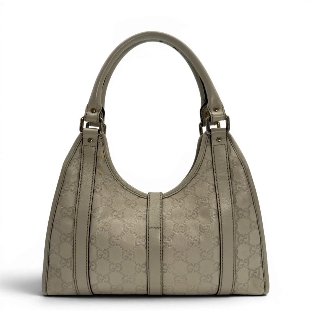 https://cdn.shopify.com/s/files/1/0564/9376/8855/files/Gucci_Schultertasche_New_Jackie_small_aus_Leder_monogram_weiss_vintage_GG7189.webp?v=1778669916