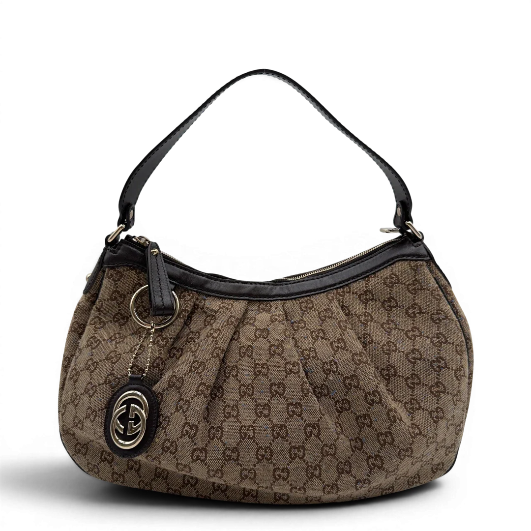 https://cdn.shopify.com/s/files/1/0564/9376/8855/files/Gucci_Schultertasche_Sukey_One_monogram_braun_1.webp?v=1782905169