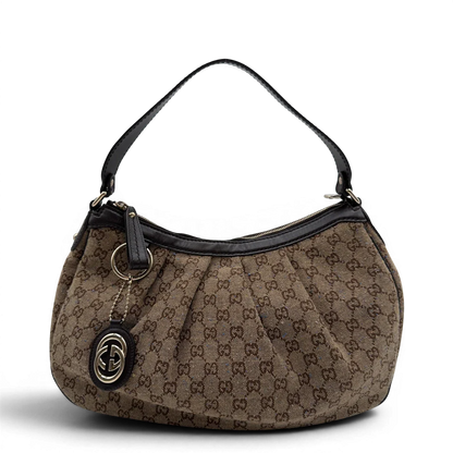 https://cdn.shopify.com/s/files/1/0564/9376/8855/files/Gucci_Schultertasche_Sukey_One_monogram_braun_1.webp?v=1782905169