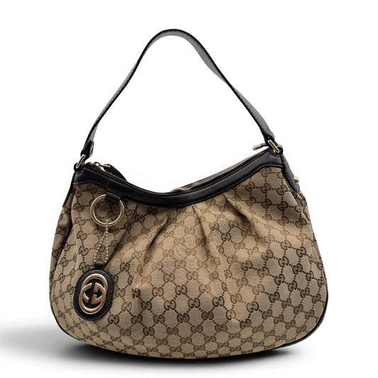 https://cdn.shopify.com/s/files/1/0564/9376/8855/files/Gucci_Schultertasche_Sukey_One_monogram_braun_1_f5e1bdb9-4d1d-4aaf-8fc3-4716e9dfb3cc.webp?v=1783514603