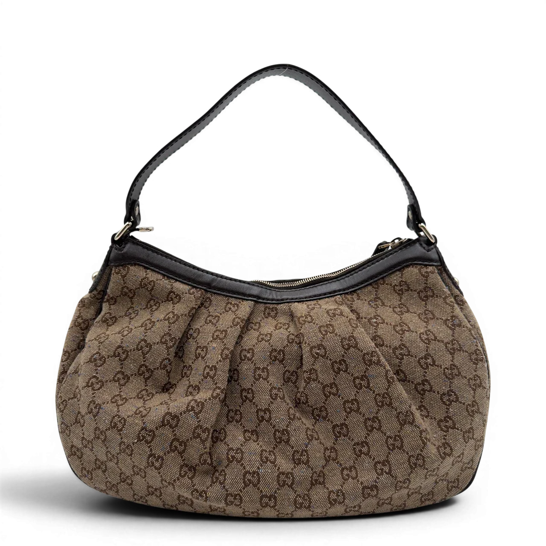 https://cdn.shopify.com/s/files/1/0564/9376/8855/files/Gucci_Schultertasche_Sukey_One_monogram_braun_2.webp?v=1782905169