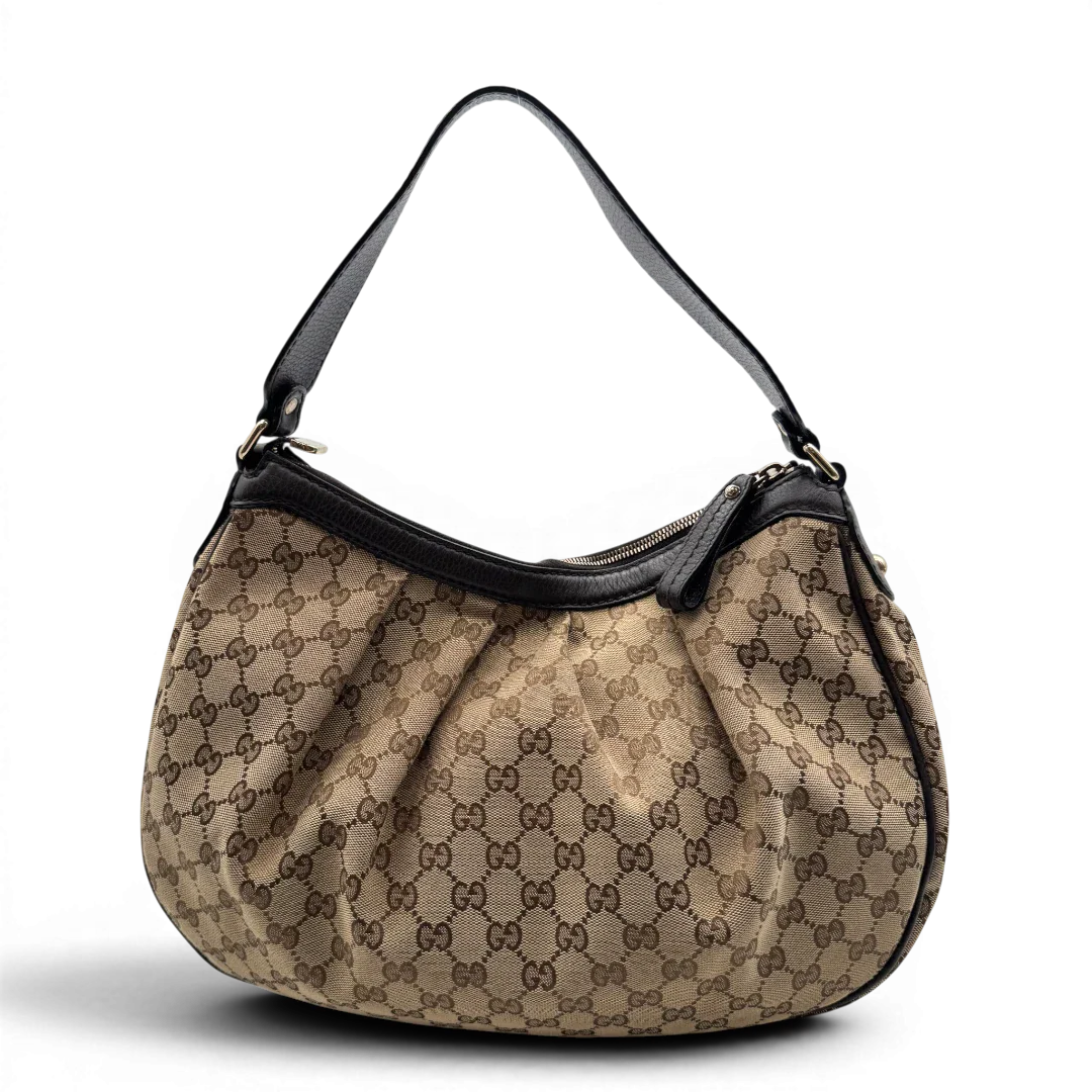 https://cdn.shopify.com/s/files/1/0564/9376/8855/files/Gucci_Schultertasche_Sukey_One_monogram_braun_4_9f945c73-0336-4b02-8e0e-6b668aebb1ce.webp?v=1783514604