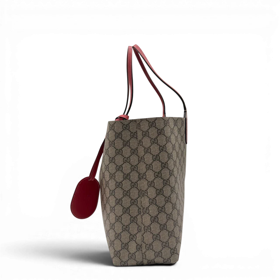 https://cdn.shopify.com/s/files/1/0564/9376/8855/files/Gucci_Shopper_Reversible_Tote_GG_Supreme_monogram_beige_3.webp?v=1781713704